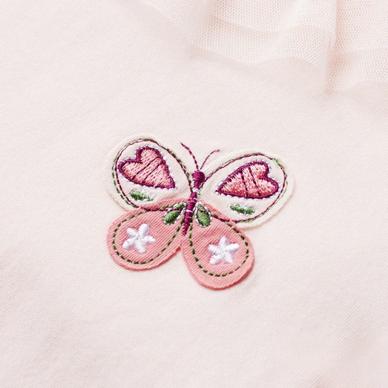 Raised embroidered butterfly with pink heart wings on light pink fabric