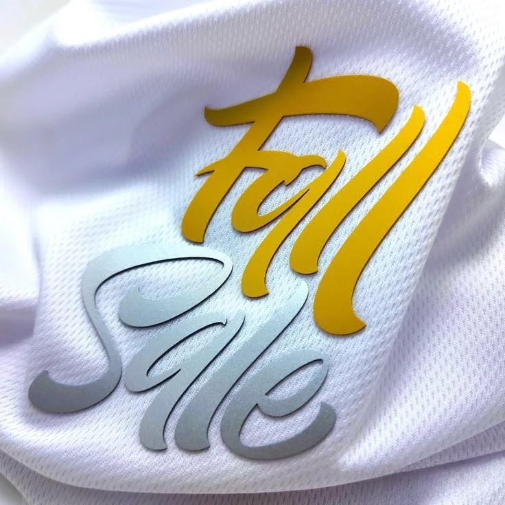 Raised yellow and grey silicone script lettering on white mesh fabric
