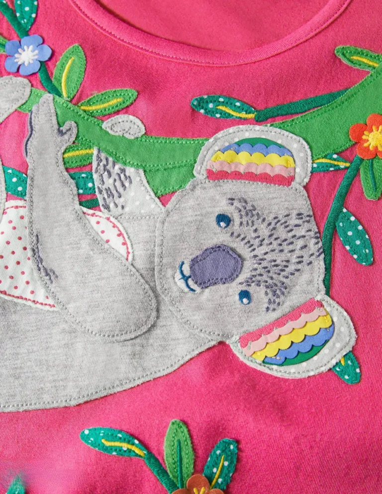 Appliqué koala hanging from a branch on a pink kids top
