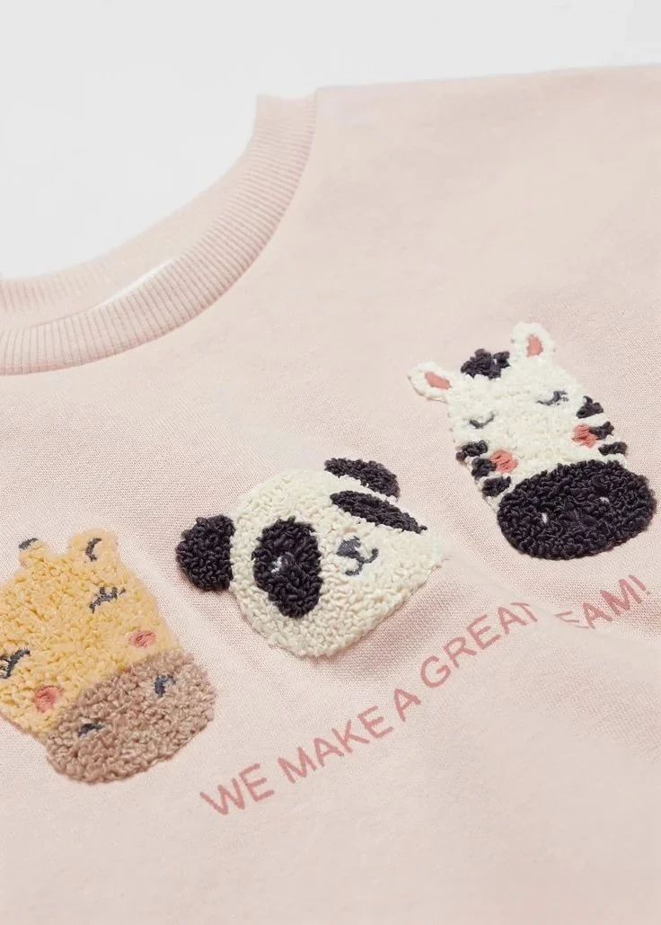 Chenille giraffe, panda and zebra faces on a pale pink sweatshirt