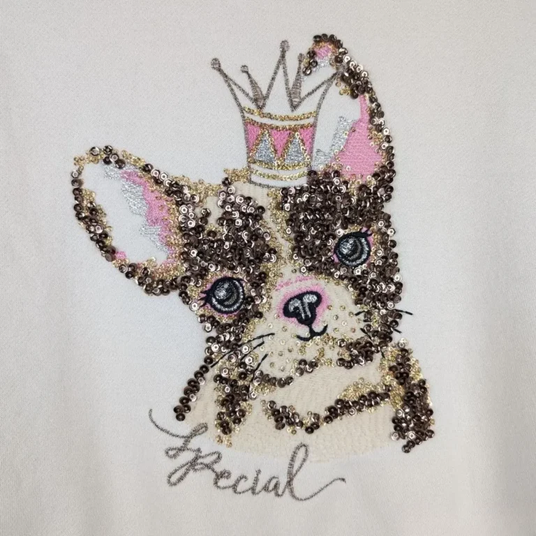 Sequin and bead French bulldog wearing a crown on a white top